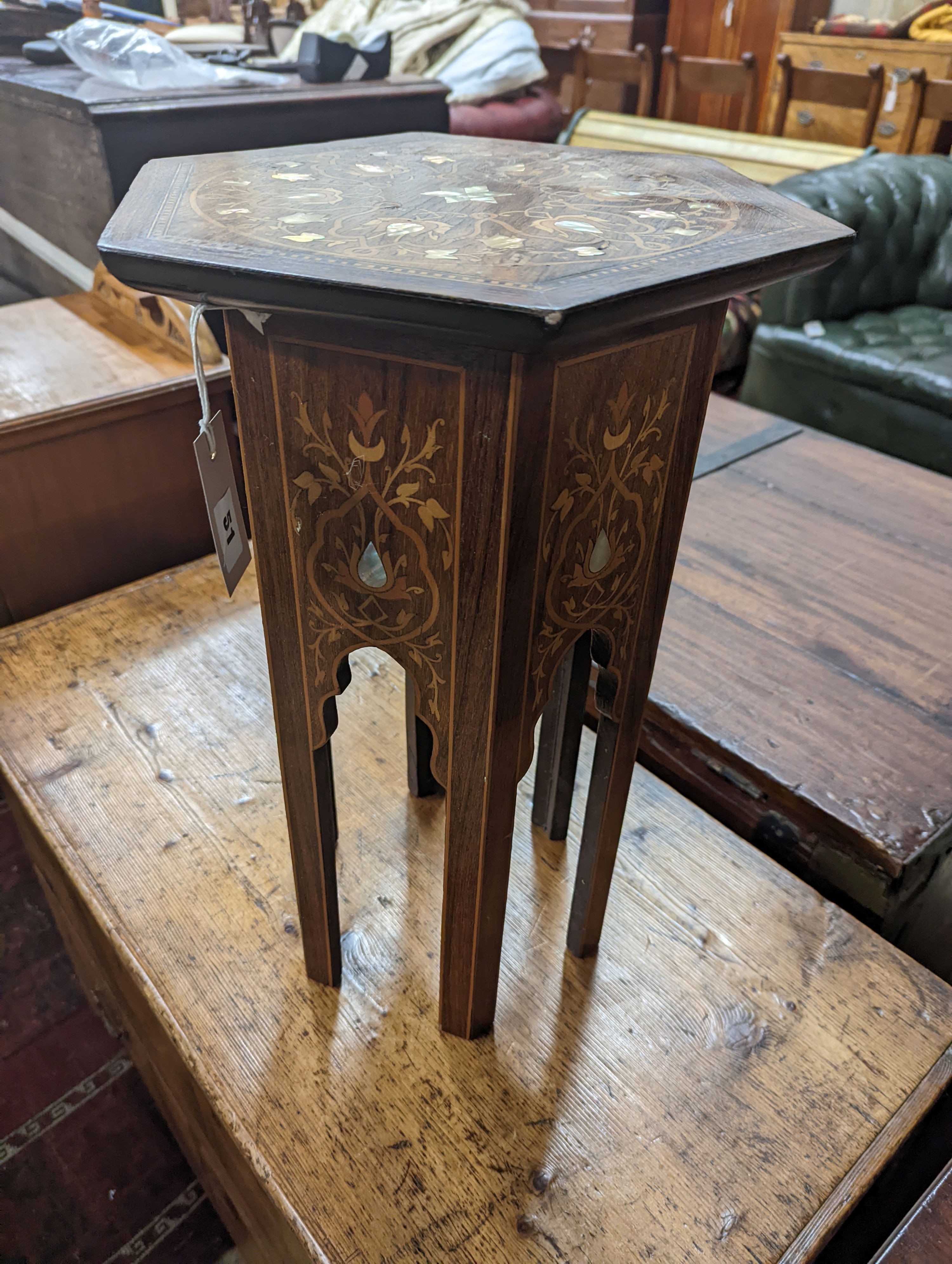 A Moorish mother of pearl and marquetry inlaid hexagonal occasional table, width 29cm, height 50cm